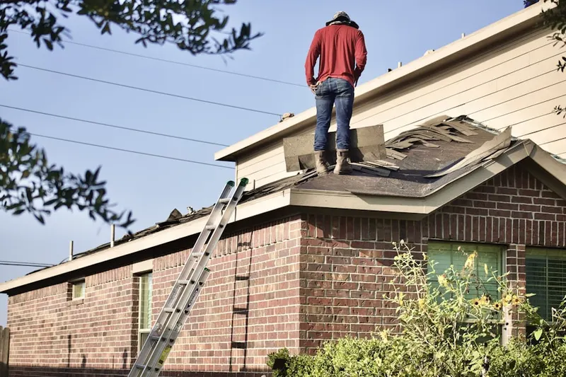 Professional roofer working on a residential roof in Goosetown
